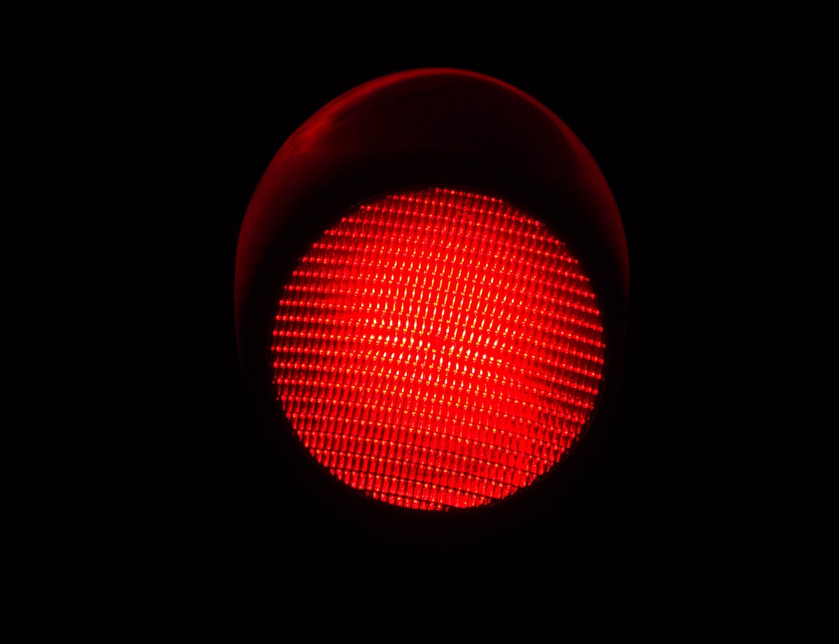 shutterstock 740169646 red light red traffic light against a black background